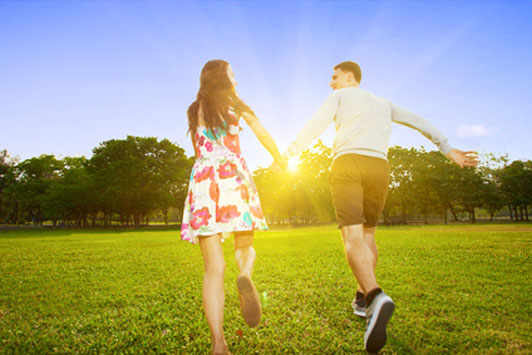 Young couple outside in the park in motion