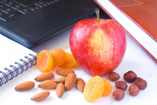 apple nuts and dried fruit on desk