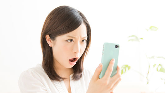 young women on smartphone with surprised look