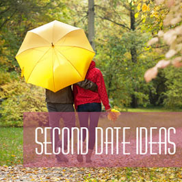 couple walking in park under umbrella