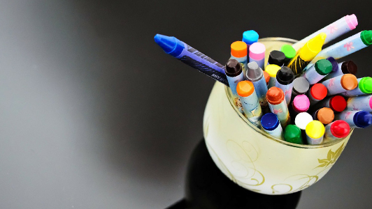 Crayons in a white jar.