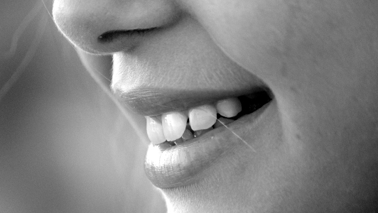 Close up of a girl's lips smiling.