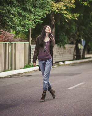 woman walking down the middle of road