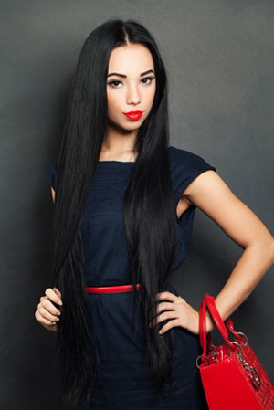woman with long hair holding red bag