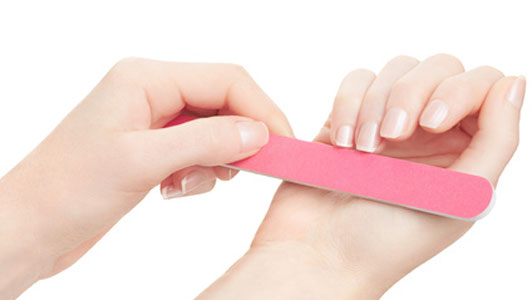 woman filing nails