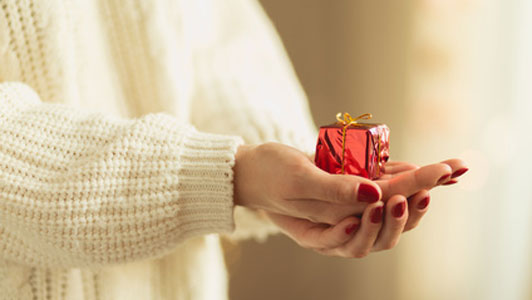 small gift in hands of woman