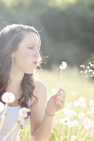 woman blowing flower