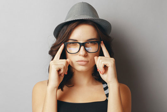 young woman in hat and glasses