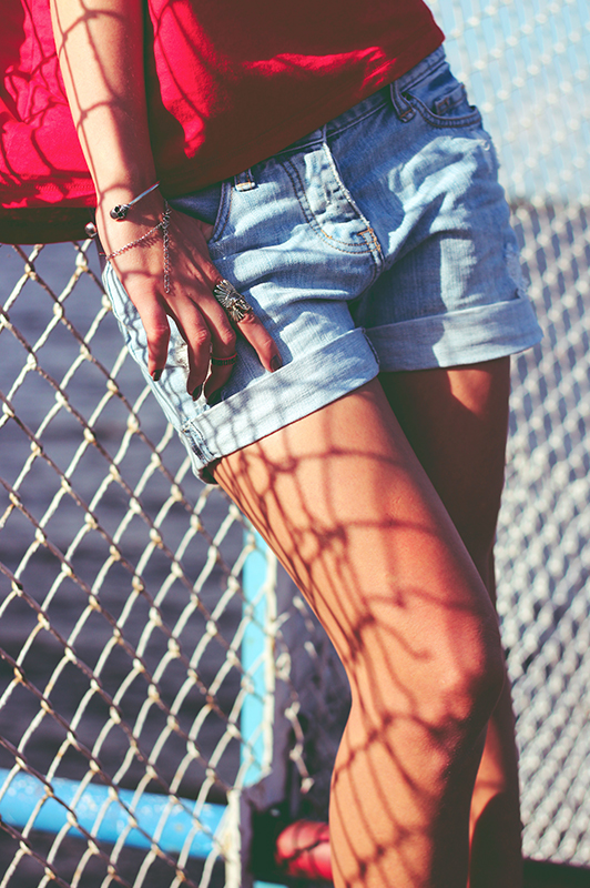 lower body of girl standing against fence