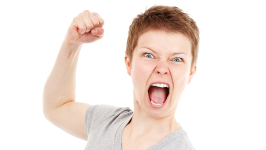 A woman yelling and holding her fist in the air