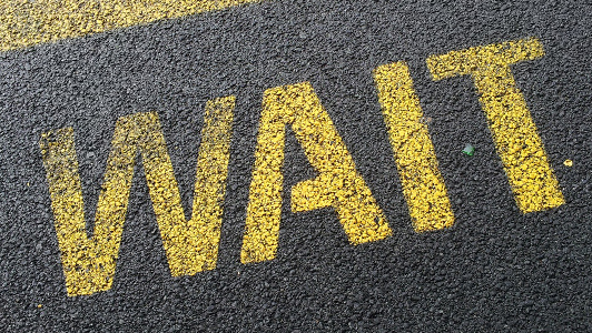 Sign on the road saying 'wait'