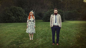 two people standing in meadow