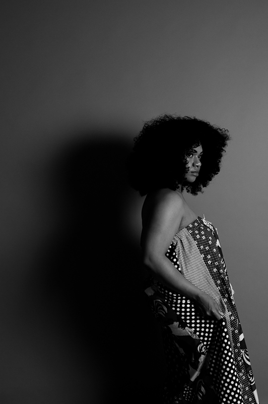 Girl with afro wearing a long dress.