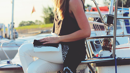 girl sitting by the yacht