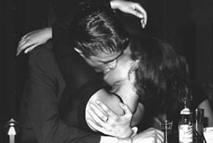 black and white photo of couple kissing fervently