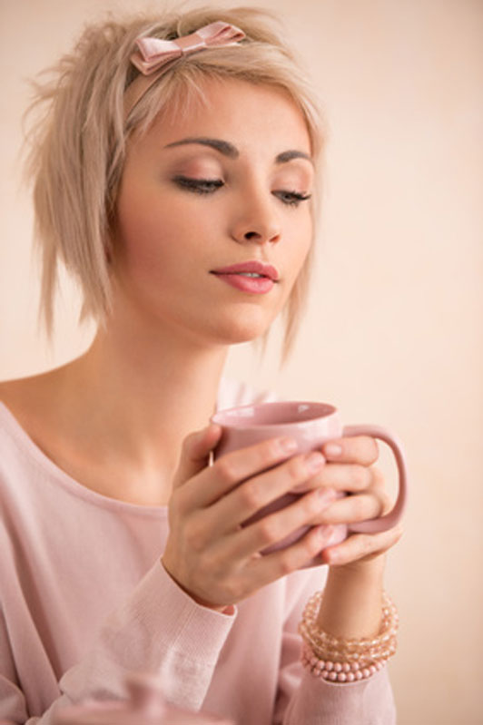 woman holding cup of tea