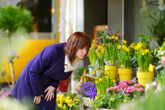 girl looking at flowers