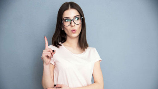 woman wearing glasses holding pointer finger up