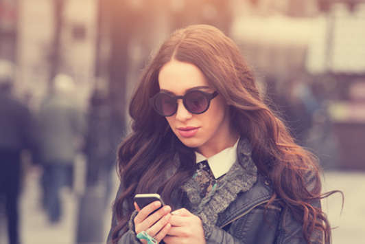 girl in sunglasses texting