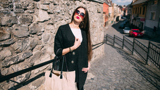 girl holding bag on street