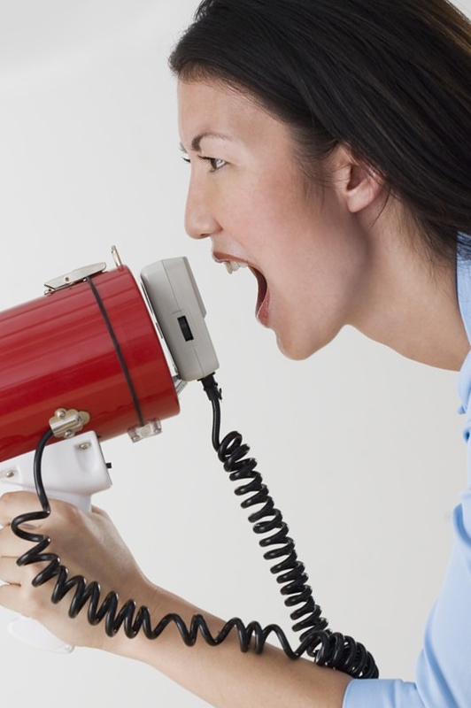 Woman with a megaphone yelling.