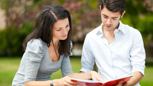 girl pointing at guys notes