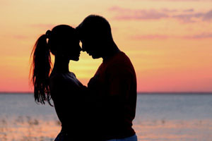 Guy and a girl hugging in the sunset