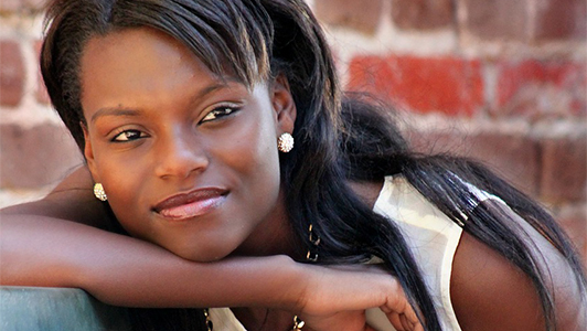 Pretty girl in white tee resting her head on her arm.