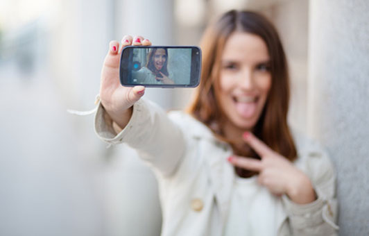 young woman taking a picture of herself