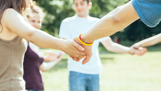 circle of people holding openly holding hands