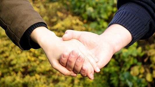 A couple holding hands.