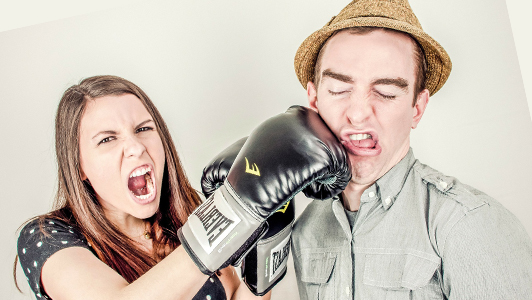 A girl punching a guy in the face.