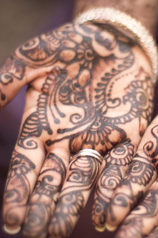 Woman's palm covered in henna.