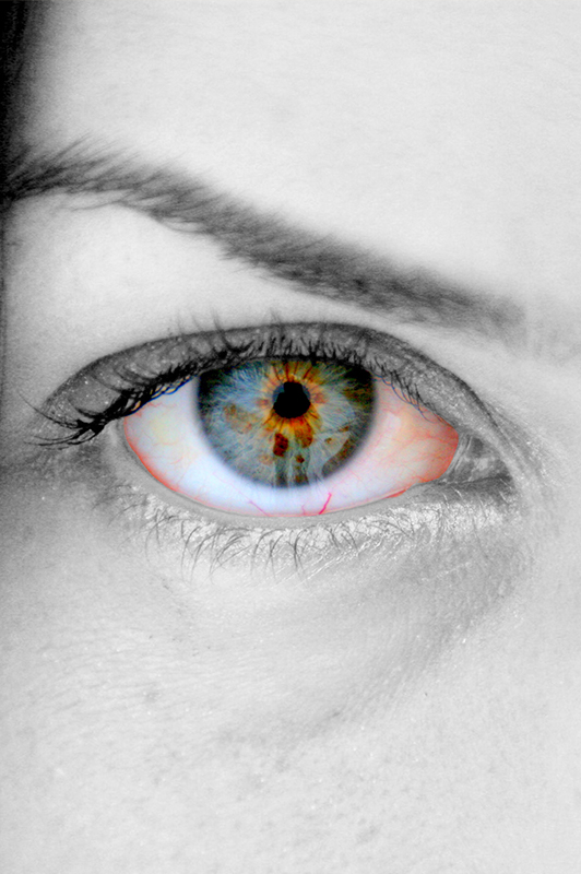 Black and gray photo of a girl's eye, and the eye is in colour.