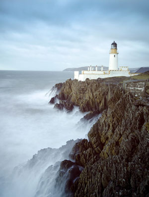 lighthouse on side of cliff