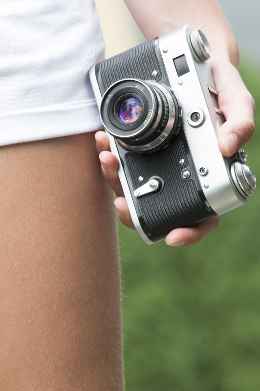A close-up of a girl holding a camera.