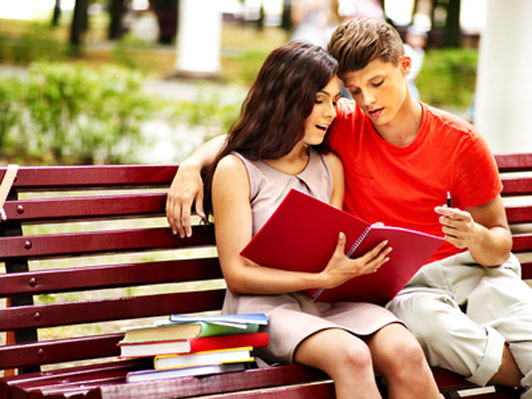 young couple studying in the park