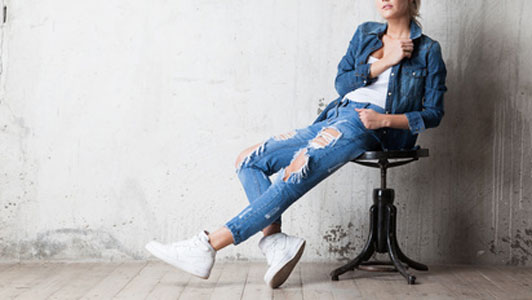 women in denim jacket wearing jeans and white tennis shoes