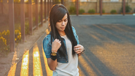 light on woman wearing fashionable high cropped denim jacket