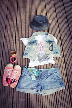 cropped denim urban outfit laid out on wood floor