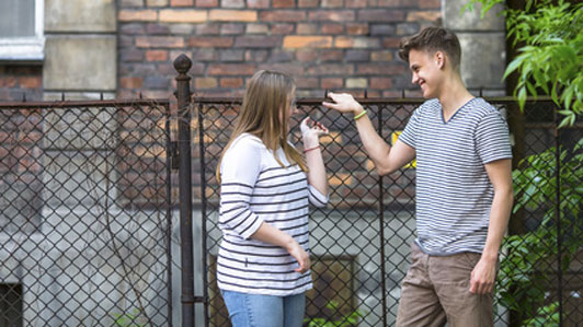 girl facing guy outside talking