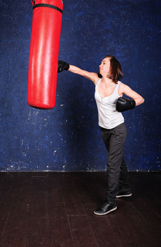 woman venting out at punching bag