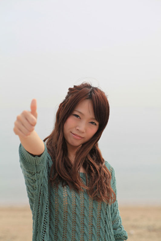 woman with long hair giving thumbs up