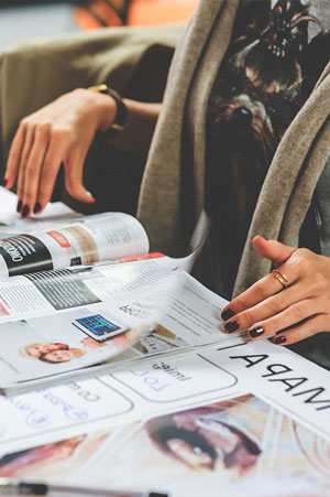 woman reading through magazines