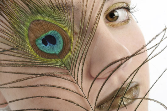 women looking through peacock eye