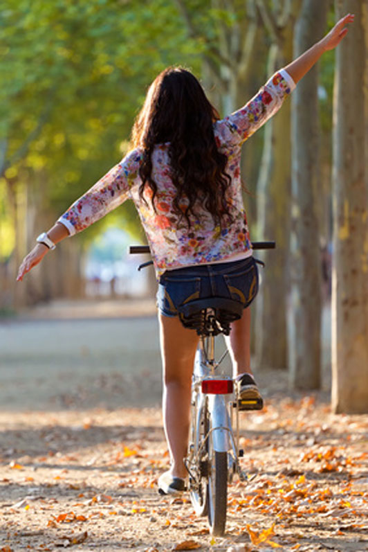 woman riding bike no handle bars