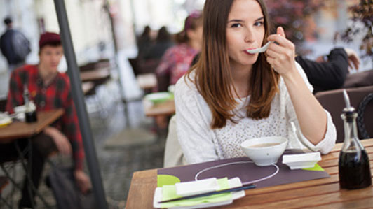 young women eating at restaurant