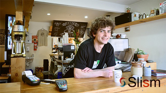 guy with coffee standing at a counter