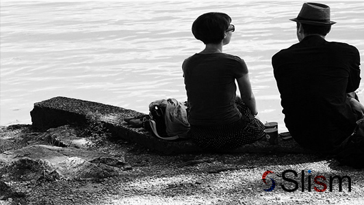 retro couple sitting on a beach