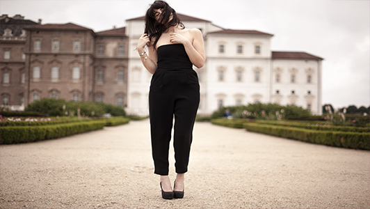 Girl in black elegant jumpsuit and high heels.